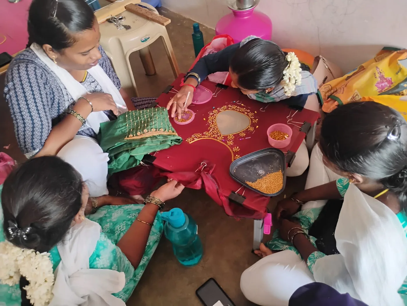 Learners practicing detailed Aari embroidery together